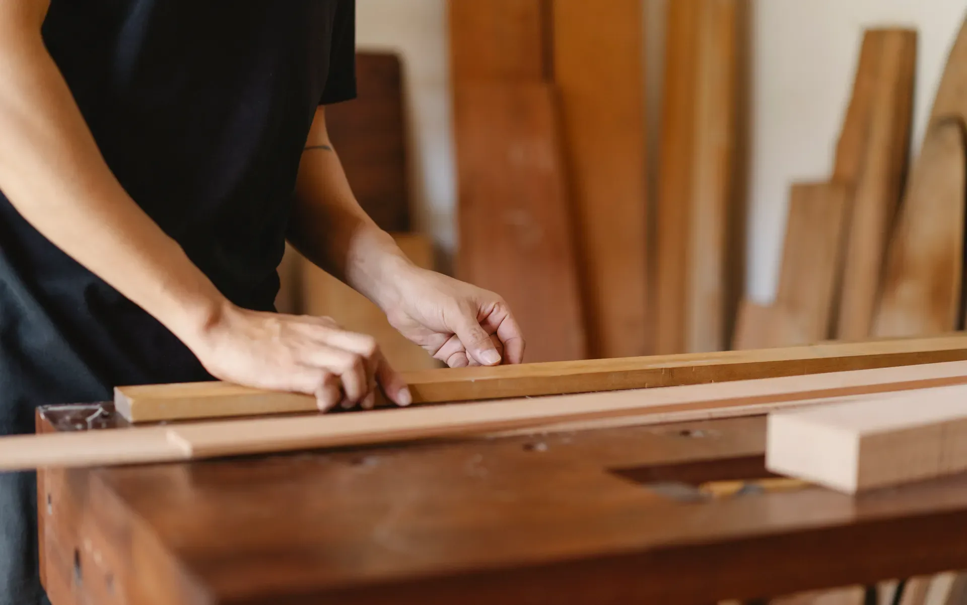 Craftsperson planing timber in a workshop